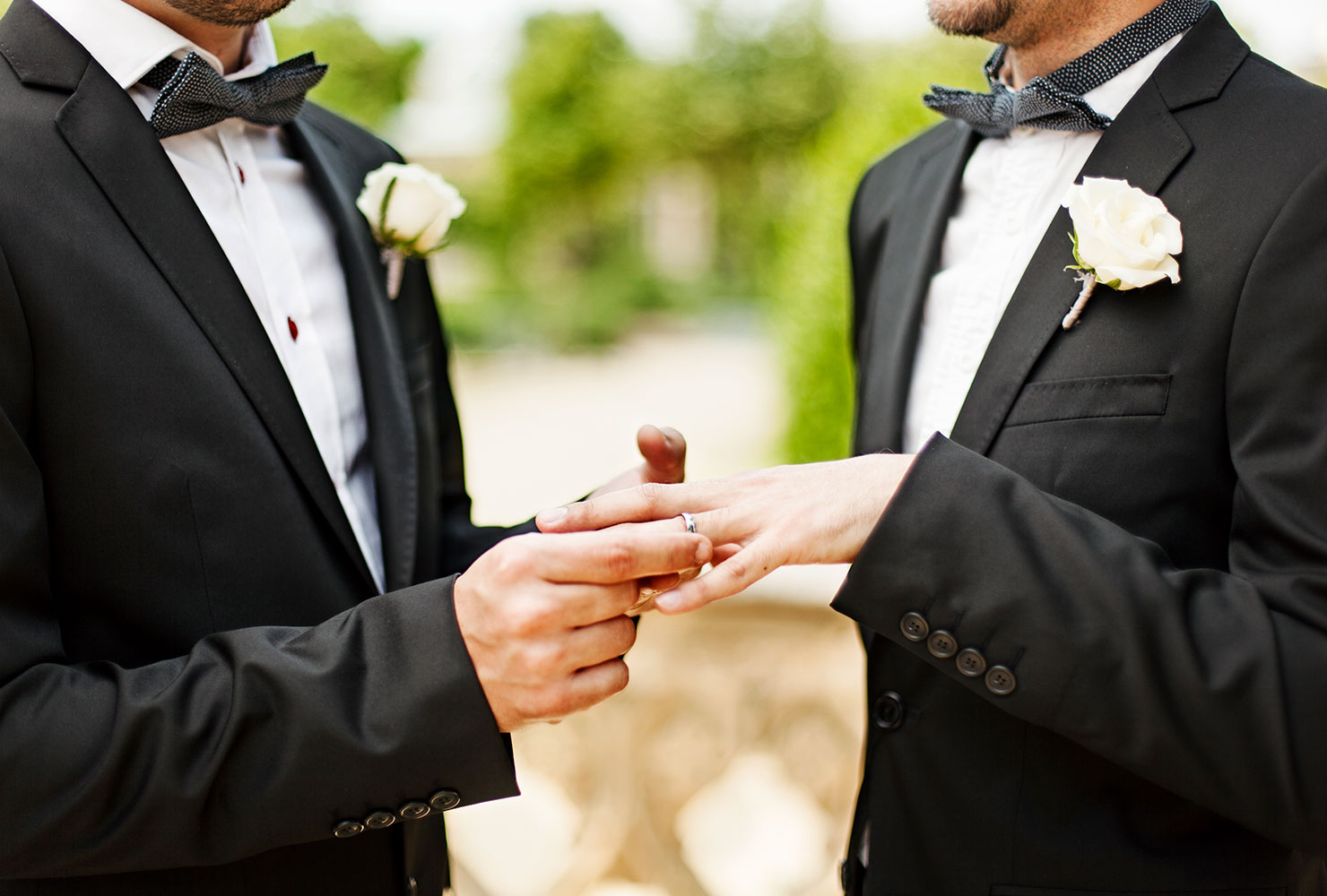 couple at the altar exchanging rings.